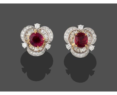 A Pair of Ruby and Diamond Earrings, realistically modelled as clover motifs, the oval cut rubies within a border of tapered 