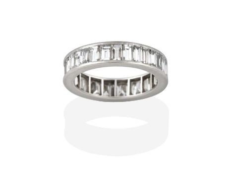 A Diamond Eternity Ring, thirty-two baguette cut diamonds in a white channel setting, total estimated diamond weight 2.50 car