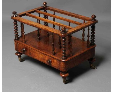 A VICTORIAN BURR WALNUT CANTERBURY of rounded oblong form with baluster turned finials on bobbin turned corner posts, three d