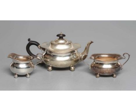 AN EDWARDIAN SILVER THREE PIECE BACHELOR'S TEA SERVICE, by Stewart Dawson &amp; Co Ltd., Birmingham 1910, of oblong baluster 