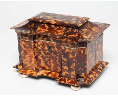 A TORTOISESHELL TEA CADDY, early 19th century, of sarcophagus form with ivory trim, the hinged lid opening to interior with t