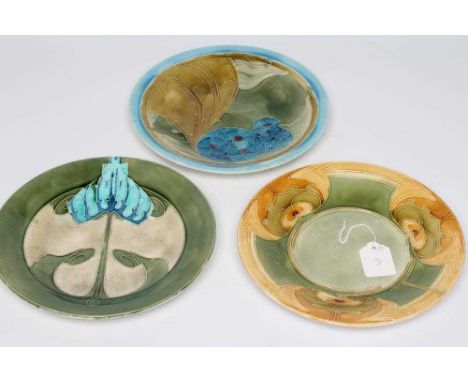 THREE MINTONS LTD. EARTHENWARE SECESSIONIST PLATES, c.1900, of plain circular form, variously tubelined and painted in typica