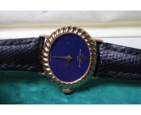 A LADY'S 18CT GOLD BAUME &amp; MERCIER WRISTWATCH, the oval lapis lazuli dial inscribed in gilt with maker's name and applied