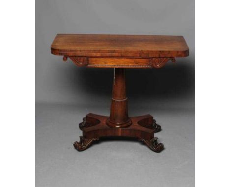 A REGENCY ROSEWOOD FOLDING CARD TABLE, early 19th century, the rounded oblong swivel top opening to a green baize lined inter