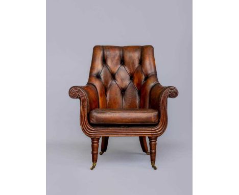 A REGENCY MAHOGANY AND STAINED WOOD BERGERE, early 19th century, upholstered in brown leatherette with a squab cushion, the r