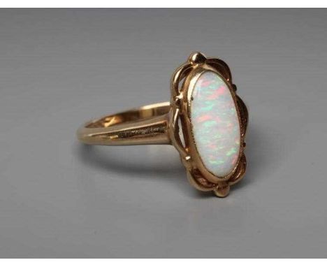 AN OPAL DRESS RING, the oval cabochon polished stone collet set to an open wavy mount and plain shank stamped 14K, size M (Es