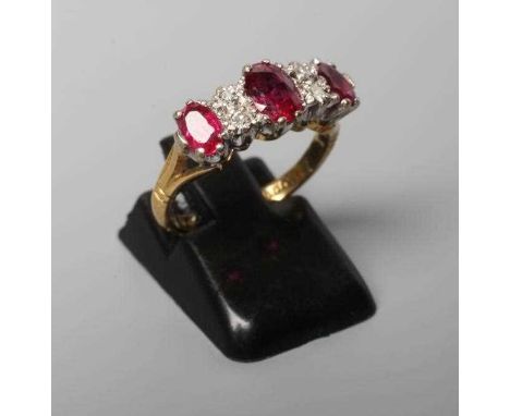 A RUBY AND DIAMOND RING, the three oval facet cut rubies claw set with two pairs of small brilliant cut diamonds between, to 
