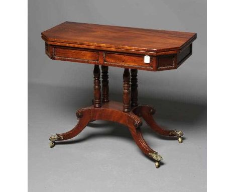 A REGENCY MAHOGANY FOLDING CARD TABLE, early 19th century, of canted oblong form, the swivel top opening to a baize lining ov