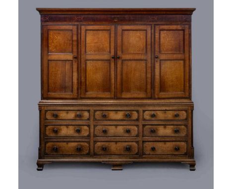A LARGE GEORGIAN OAK AND MAHOGANY BANDED HOUSEKEEPER’S CUPBOARD, late 18th century, the moulded cornice over string inlaid fr