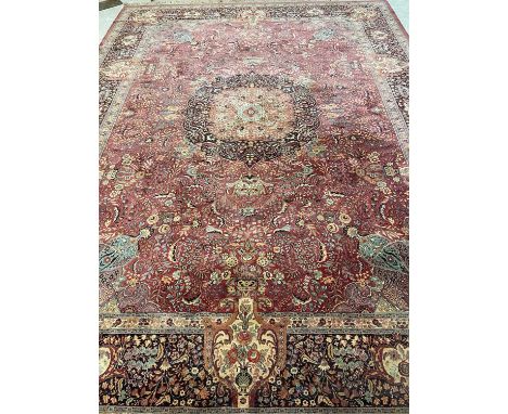 A BRUSSELS PERSIAN DESIGN CARPET, 20th century, the dusky pink field in an all-over floral pattern with foliate scrolls in sh