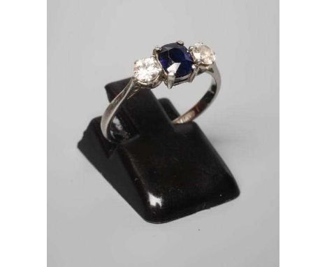 A SAPPHIRE AND DIAMOND THREE STONE RING, the central cushion cut sapphire claw set and flanked by two old cut stones, each of