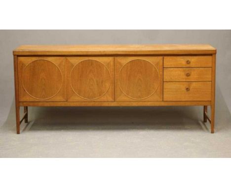 V A NATHAN TEAK SIDEBOARD, mid 20th century, the fascia with two cupboard doors each with a circular panel, flanked on one si