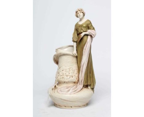 A ROYAL DUX PORCELAIN ART NOUVEAU FIGURAL VASE, early 20th century, modelled as a young maiden wearing a long green dress, ho