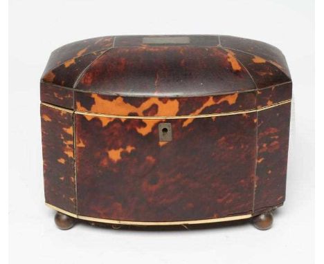 A TORTOISESHELL TEA CADDY, early 19th century, with hinged shallow domed lid enclosing a two compartment interior, raised on 