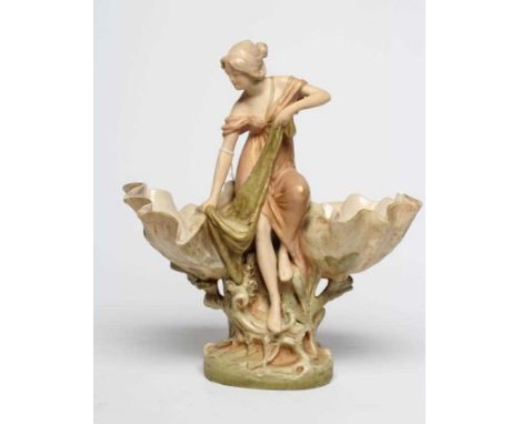 ROYAL DUX PORCELAIN ART NOUVEAU FIGURAL CENTREPIECE modelled as a young maiden standing between a pair of clam shells resting