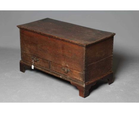 A GEORGIAN OAK BOARDED CHEST, late 18th century, the cleated plank lid opening to a void interior, two base drawers with bras