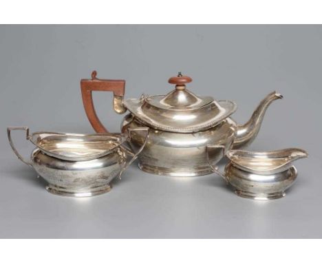 A SILVER THREE PIECE TEA SERVICE, by Henry Clifford Davis, Birmingham 1926, of oval baluster form with everted gadrooned rim,