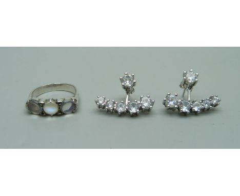 A silver and moonstone ring and a pair of silver and clear stone earrings 