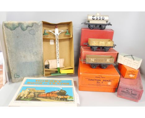 A box of Hornby O gauge tinplate wagons, accessories, boxes and a 'Hornby Book of Trains' reprint of the 1927 edition. Includ