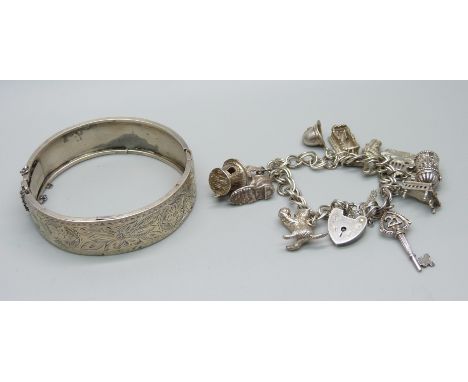 A silver charm bracelet and a bangle, bangle a/f, charm bracelet 41g 