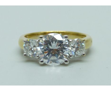 A silver gilt three stone simulated diamond ring, P 