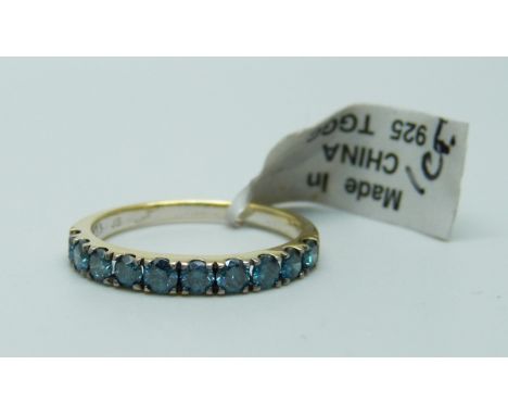 A silver gilt and blue stone half eternity ring, S 