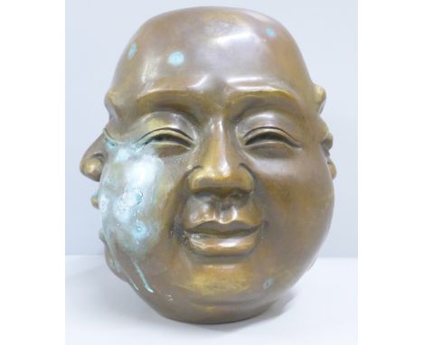 A bronze four headed Buddha head