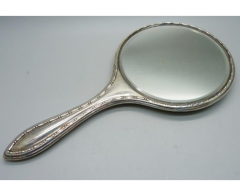 A silver backed hand mirror 