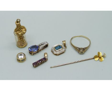 A 9ct gold ring, four 9ct gold pendants, a 9ct gold charm and a yellow metal stick pin marked 15c, 11.1g 
