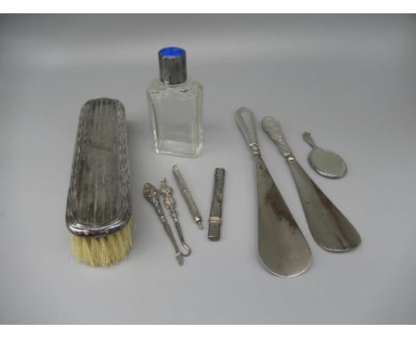 Glass dressing table bottle with hallmarked silver and blue enamel lid, a dressing table brush with hallmarked silver top,  t