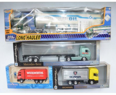 Two boxed large 1/32 scale diecast and plastic truck models by New Ray, part of their Long Hauler collection, Mercedes Benz 1