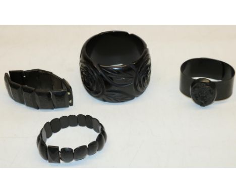 Collection of mourning jewellery: jet bangle with carved rose design, D7.5cm, celluloid bangle with applied oval jet piece ca