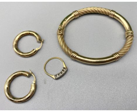 Yellow metal bangle with worn markings, a pair of gold hoops, stamped 375, and a 9ct gold and platinum diamond ring, stamped 