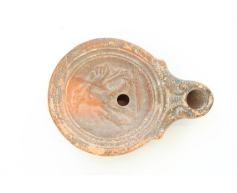 C1st CE Ancient Cypriot Roman terracotta oil lamp, central well decorated in relief with a hunter with dog, 8.5cm x 6cmProven