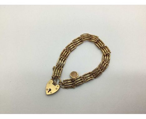 A 9ct Gold Gate Link Style Bracelet, suspending a small 9ct gold St. Christopher charm pendant, to 9ct gold heart shape padlo