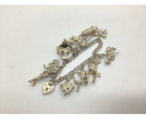 A Double Curb Link Charm Bracelet, suspending numerous novelty charms, including 21 Key, Bullfighter and Bull, Vintage Car, e