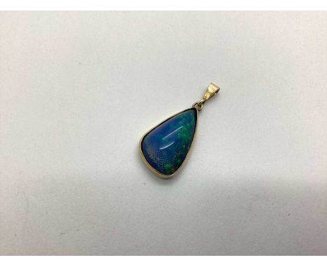 A Black Opal (Doublet?) Pendant, irregular collet set (closed back setting).