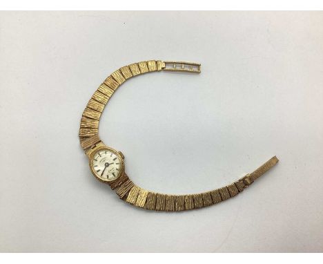 Rotary; A 9ct Gold Cased Ladies Wristwatch, to integral textured tapering bracelet with 9ct gold clasp. (Total weight 14grams