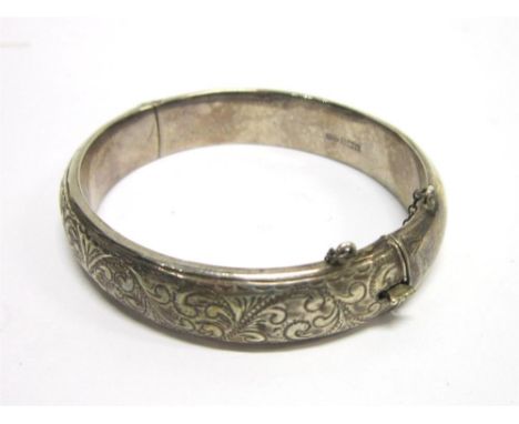A SILVER HINGED BANGLE Birmingham 1959, with half engraved decoration, 5.8cm inner diameter, 23g gross