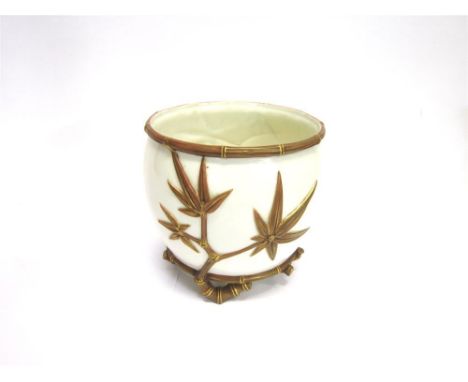 A ROYAL WORCESTER JARDINIERE decorated in relief with shooting bamboo, painted brown and highlighted in gilt, against a cream