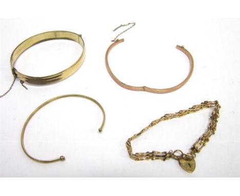 A 9CT GOLD HINGED BANGLE with a 9ct gold torque bangle and a 9ct gold three bar gate bracelet; 10.3g gross; also with a gilt 