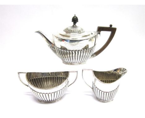 A LATE VICTORIAN SILVER THREE PIECE TEA SERVICE by Gibson and Langman, London 1898, of oval gadrooned form, 750g (24 troy ozs