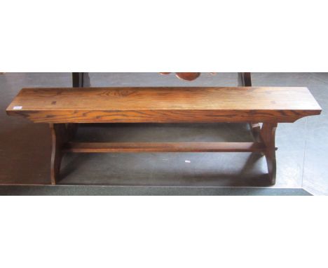 AN ARTS & CRAFTS STYLE OAK BENCH The rectangular top 19.5 x 150cm, on shaped end supports united by stretcher, 48cm high, car