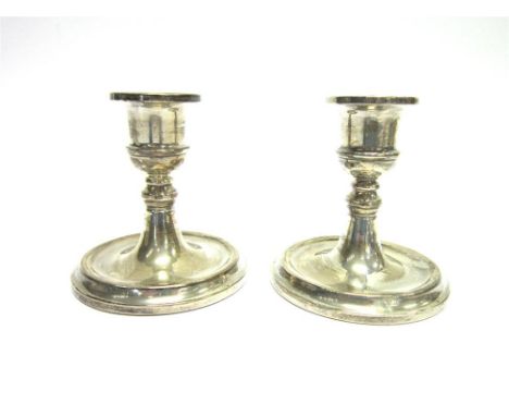 A PAIR OF SILVER DESK CANDLESTICKS by W.I. Broadway & Co, Birmingham 1979, the circular sunken base rising to a short knopped