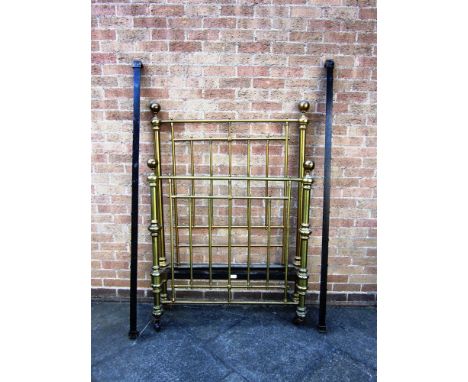 A PAIR OF VICTORIAN BRASS 3'6' BED-ENDS AND IRONS with retailer's label for Maple & Co. (one caster missing)