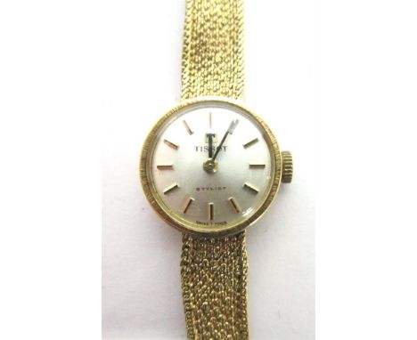 TISSOT, STYLIST, A LADY'S 9CT GOLD BRACELET WATCH the circular signed dial with gilt black hands and batons, the two piece ca