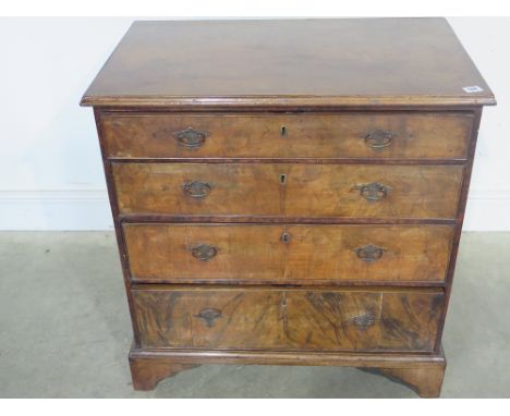 A burr and figured walnut chest of four long graduated drawers raised on bracket supports - 76 cm x 48 cm x 88 cm 
