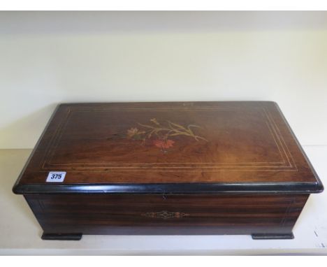 A 19th century music box playing ten airs - Height 18 cm x Width 55 cm x Depth 29 cm 
Condition report: Working order all pin