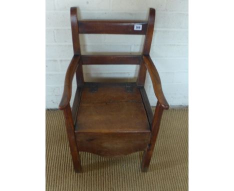 A 19th century child's elm chair, bar back with lift hinged seat covering commode fitting shaped apron raised on square suppo