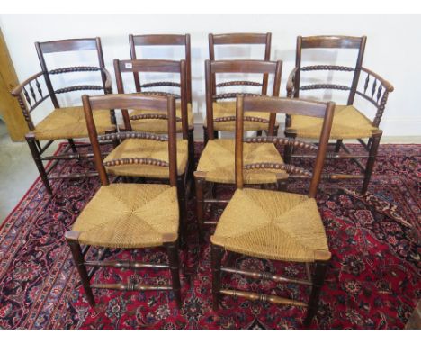 A set of eight 19th century elm bobbin turned back chairs with seagrass seats and double front stretchers including two carve